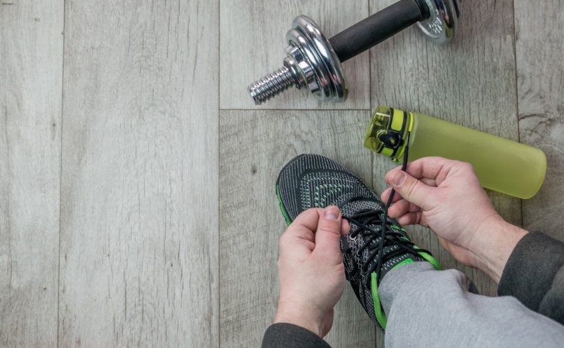 Fitness objects isolated on wooden background. Gray Sneakers, dumbbells and water bottle. Active, healthy lifestyle, sport, fitness, and objects concept. More of my photos and videos Adobe Stock:http://bit.ly/3RqlciK More of my photos and videos Shutterstock: https://www.shutterstock.com/g/ALEKSANDRBERDYUGIN My email: bermix999@gmail.com
